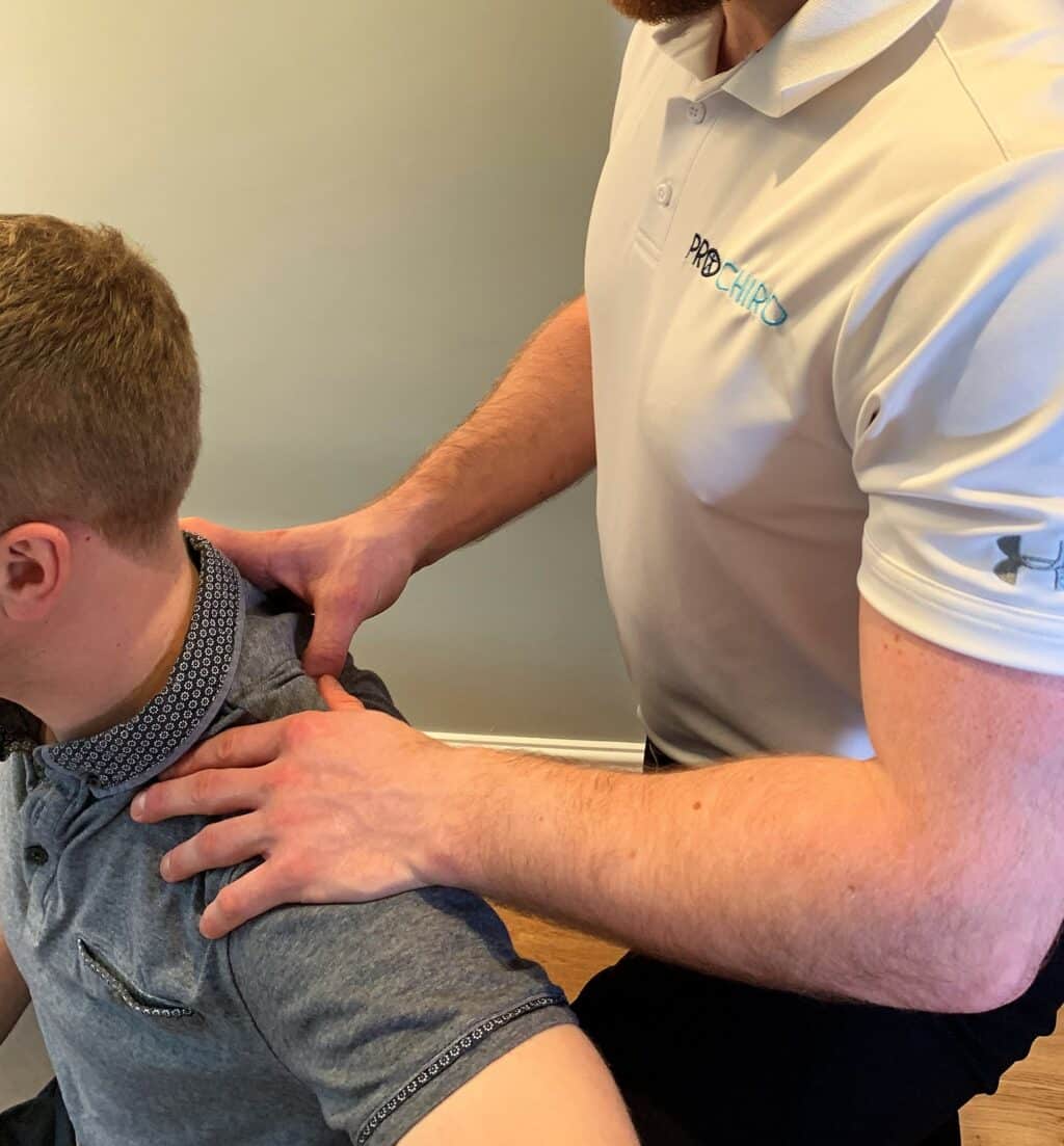 Josh French, sports chiropractor, performing soft tissue release for a shoulder sports injury.